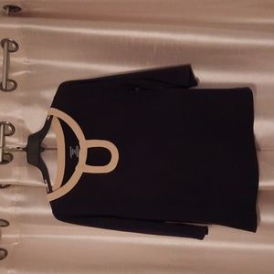 Lane Bryant size 14/16 black shirt with tan detail around neck and opening.